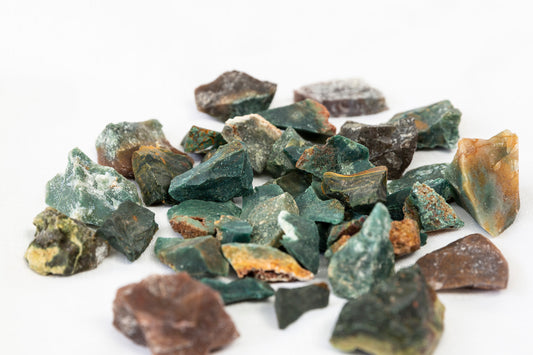 Pile of green and brown stones on a white background