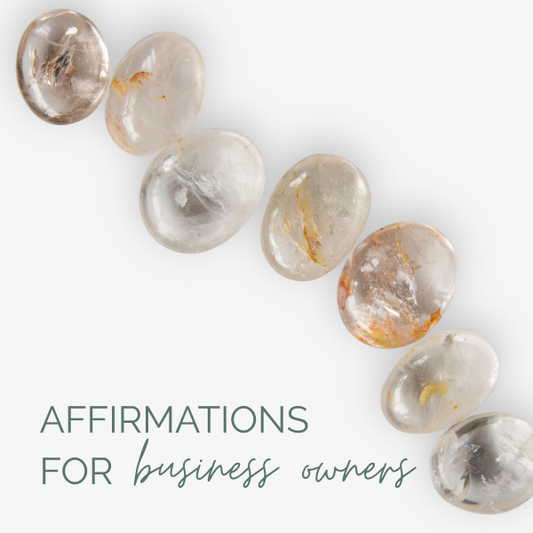 Clear quartz crystal palmstones on a white background, accompanied by text 'Affirmations for business owners'.