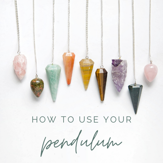 A group of colourful rough and polished crystal pendulums hanging on silver chains and the words "How to use your pendulum" on a white background