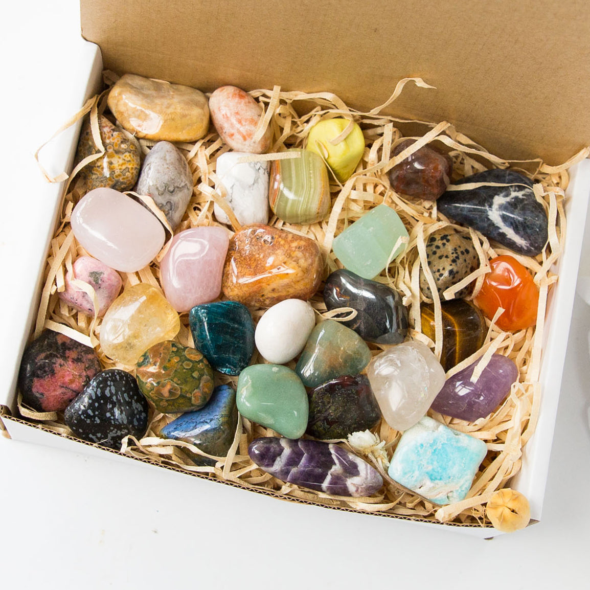 Box full of assorted tumbled crystals