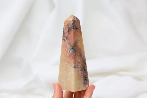 Hand holding Pink Amethyst Crystal Tower