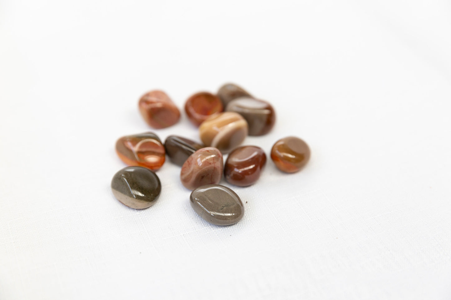 A pile of multicoloured stones on a white background