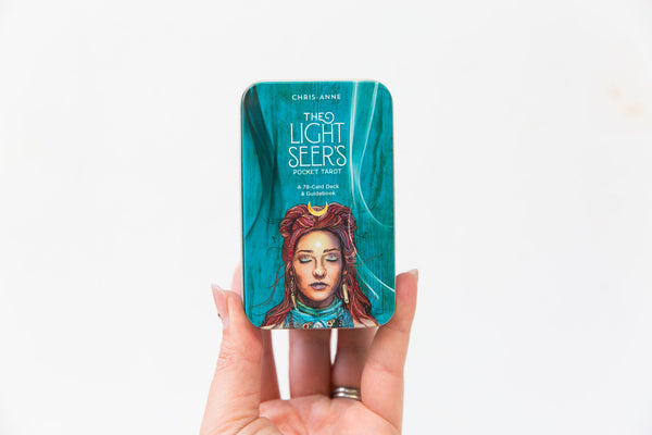 Hand holding The Light Seer's Tarot Pocket Deck 