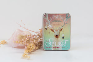 The Spirit Animal Pocket Oracle Deck beside dried flowers and a rose quartz crystal